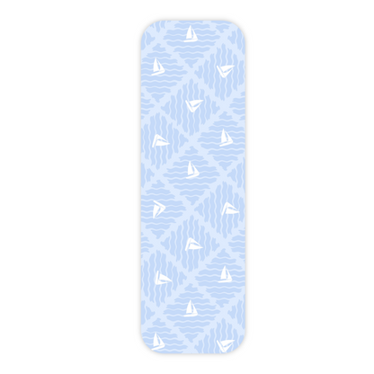 One light blue laminated bookmark displayed vertically and in the center of a plain white background. This bookmark features an all-over repeating pattern of tossed sailboats on small diamond-shaped wave patches. The bookmark has rounded corners and a slight drop shadow.