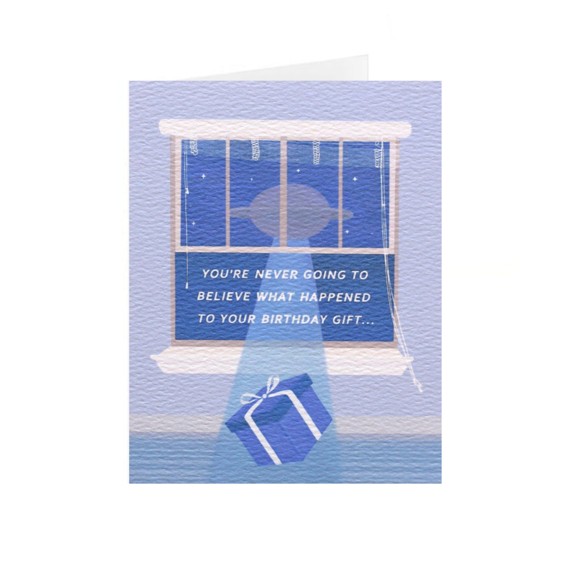 A vertical birthday card stands up on a centered white background. The card has an illustration of a blue wrapped present being lifted out of the open light blue window to a floating UFO. The white text  centered in the open window says, 'you're never going to believe what happened to your birthday gift...' In the night sky there are small stars.