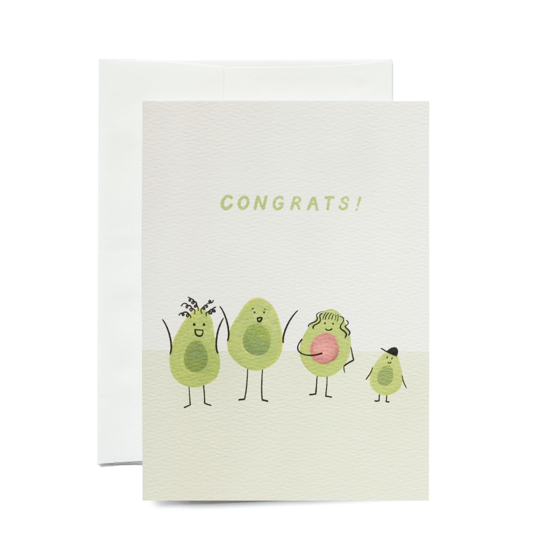 A vertical white greeting card featuring four illustrated avocado cartoon characters standing in a row on a light green ground. From left to right: an avocado with curly hair and arms raised, a tall avocado with a wide smile, a pregnant avocado with an avocado seed belly, and a small avocado wearing a black hat. The word 'Congrats!' is printed in light green sans-serif capital letters above them.