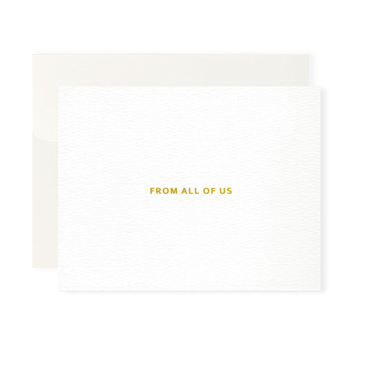 This image features a high-quality, professional greeting card and its matching envelope, set against a clean white background. The card itself is oriented horizontally, though it opens vertically. It is crafted from a heavy-weight, bright white paper with a sophisticated, rippled texture that gives it a premium, tactile appearance. Centered on the front of the card is the phrase "From All Of Us," printed in a clean, all-caps sans-serif font. The text is embossed in shiny gold-colored foil.