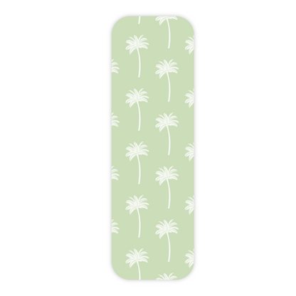 One light green laminated bookmark displayed vertically and in the center of a plain white background. This bookmark features an all-over repeating pattern of white palm trees on a plain light green background. The bookmark has rounded corners and a slight drop shadow.