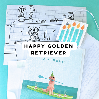 Birthday card design featuring a golden retriever, with the words “Happy Golden Retriever Birthday!” and a small illustration of the dog paddleboarding beside a black-and-white color sheet of a dog in a bathtub. stacked above the coloring sheet is a teal blue paper candles square gift tag. 