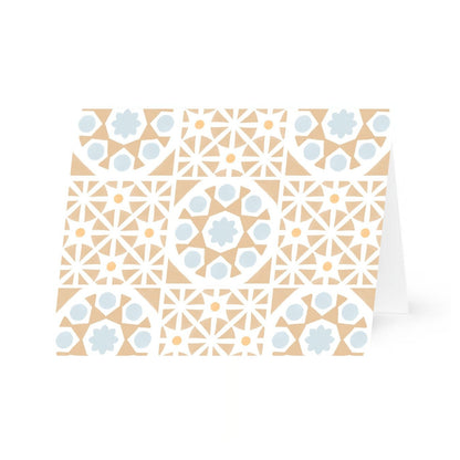 A horizontal greeting card featuring an all-over pattern of tan-colored Mediterranean tiles arranged in a symmetrical grid format. The folded is shown slightly propped open and centered against a plain white background.