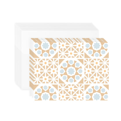 A stack of 8 horizontal greeting cards featuring an all-over pattern of tan-colored Mediterranean tiles arranged in a symmetrical grid format. The folded cards are shown laying flat stacked above 8 white envelopes. The stack of envelopes and cards are centered against a plain white background.