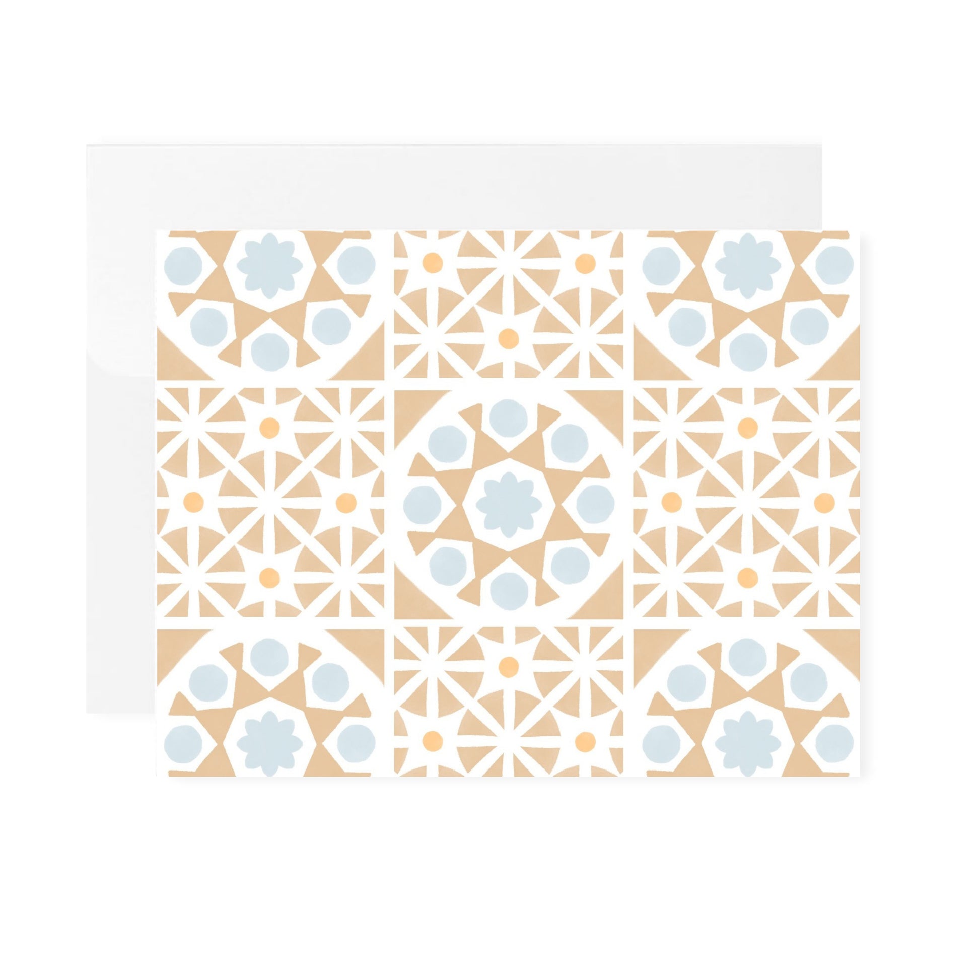 A horizontal greeting card featuring an all-over pattern of tan-colored Mediterranean tiles arranged in a symmetrical grid format. The folded card is shown laying flat with a white envelope tucked behind it. The card is centered against a plain white background.