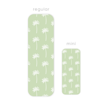 Two green rectangular laminated bookmarks with white palm tree patterns, labeled 'regular' and 'mini'.