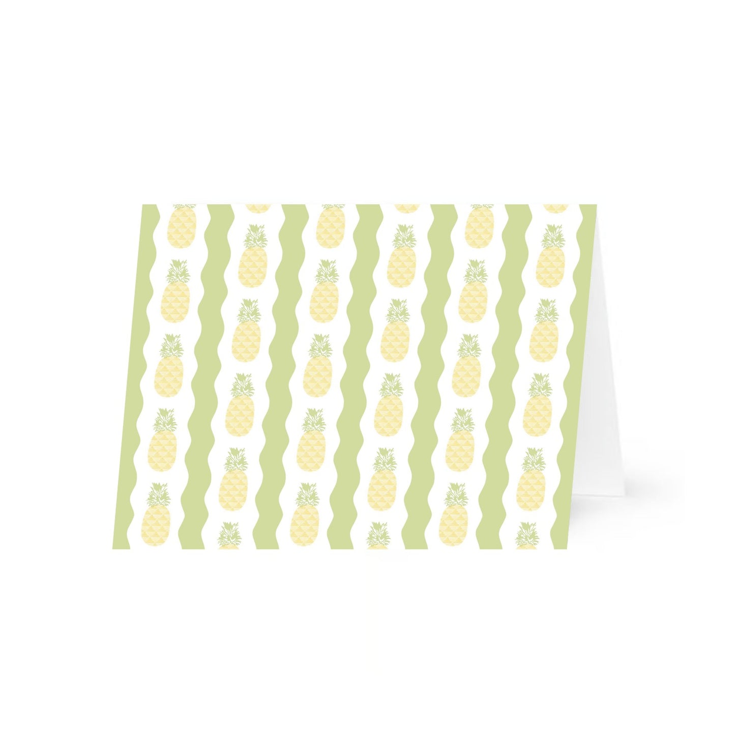 A single folded greeting card featuring a pattern of vertical rows of stylized pineapples. The pineapples have a yellow crisscross diamond pattern with green leafy tops, set against alternating white and green wavy vertical stripes. The patterned horizontal card is standing up slightly open and is centered on a white background.
